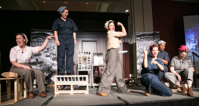 Photo of the Wild Swan Theater sharing the story of Rosie the Riveter, accompanied by ASL actor-interpreters. 