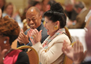 Man and woman laughing and clapping