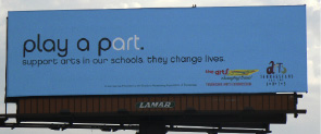 Blue Billboard saying "play a part, support arts in your schools, they change lives"