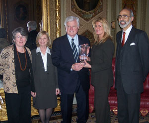 A photo of Senator Ted Kennedy being presented with the Sidney R. Yates award and standing side by side with Mary Kelley, Rhoda Pierce, Romie Munoz, and Jonathan Katz