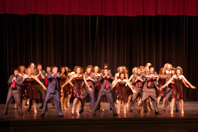The Cabell Midland High School Rhythm in Red Show Choir on stage at the Charleston Civic CenterfYi Photography by Jamie Dunbar