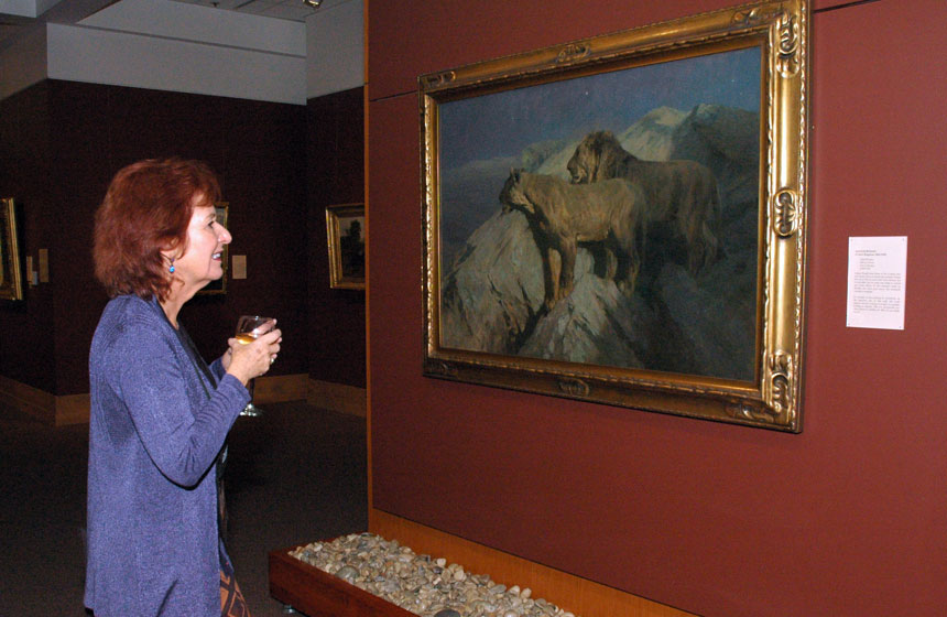 Maryland State Arts Council Chair Barbara Bershon admires a painting at the National Museum of Wildlife Art.