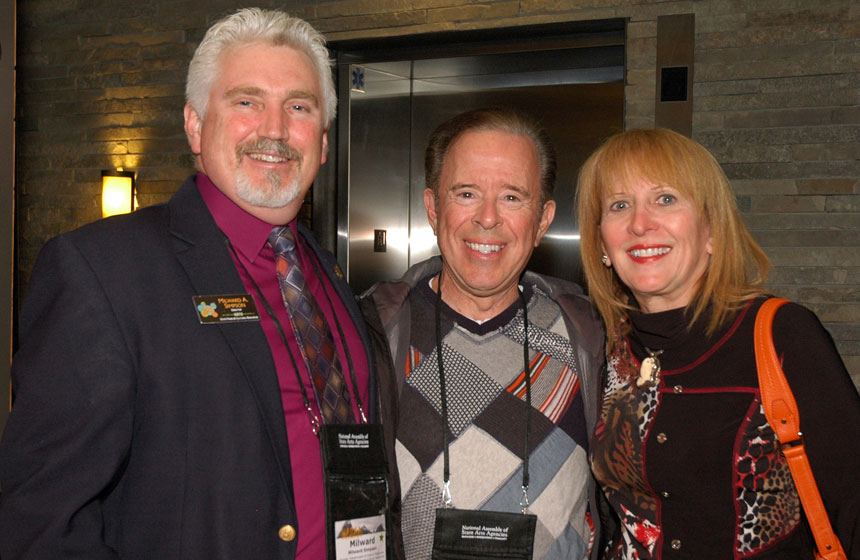 Wyoming Department of State Parks and Cultural Resources Director Milward Simpson, left, welcomes Ohio Arts Council Chair Jeff Rich and his wife, Leslie Rich.