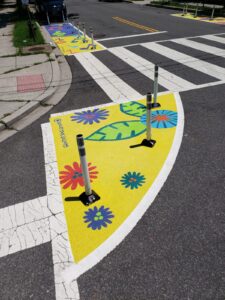Grow Your Garden! by Ashley Jaye Williams, at Drew Elementary, is a curb extension mural for the Color the Curb: School Safety Program. Image courtesy D.C. Commission on the Arts and Humanities.